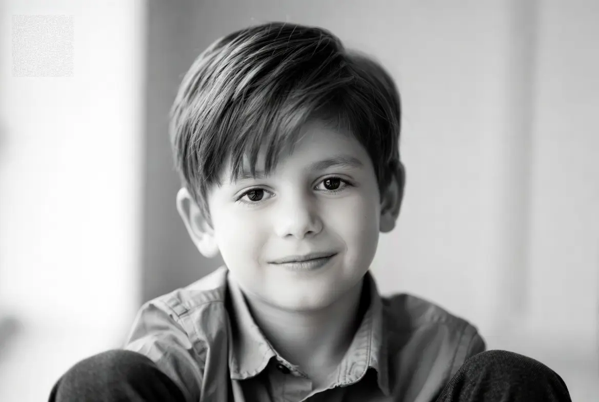 Young boy with straight hair and a neat modern haircut in a professional editorial-style portrait